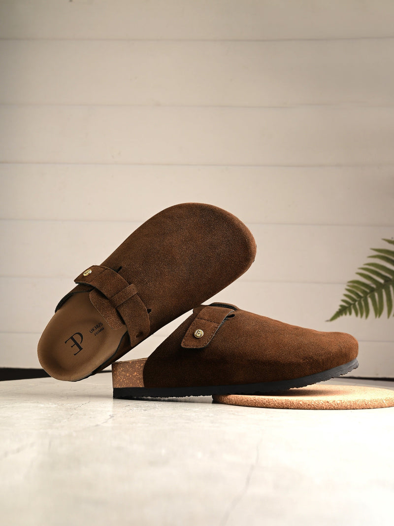 Brown suede slip-on clog with a black rubber sole and adjustable strap.