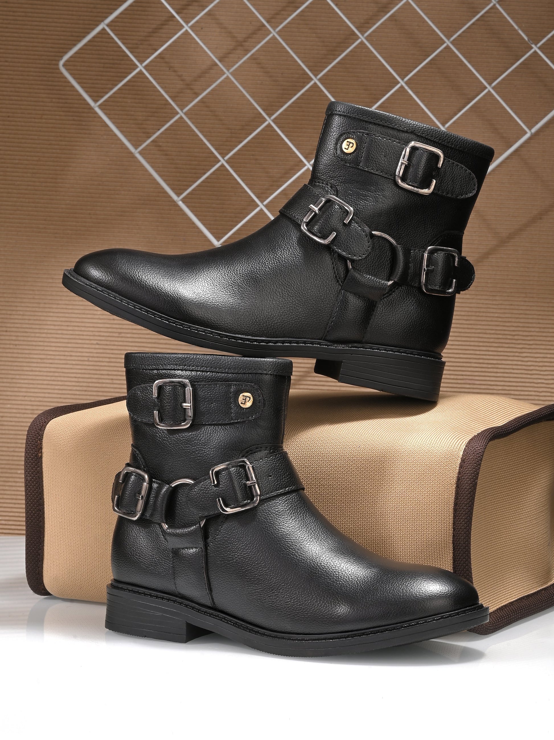 Women Black leather ankle-length boot with silver buckle accents and a low heel, perfect for casual or semi-formal wear.