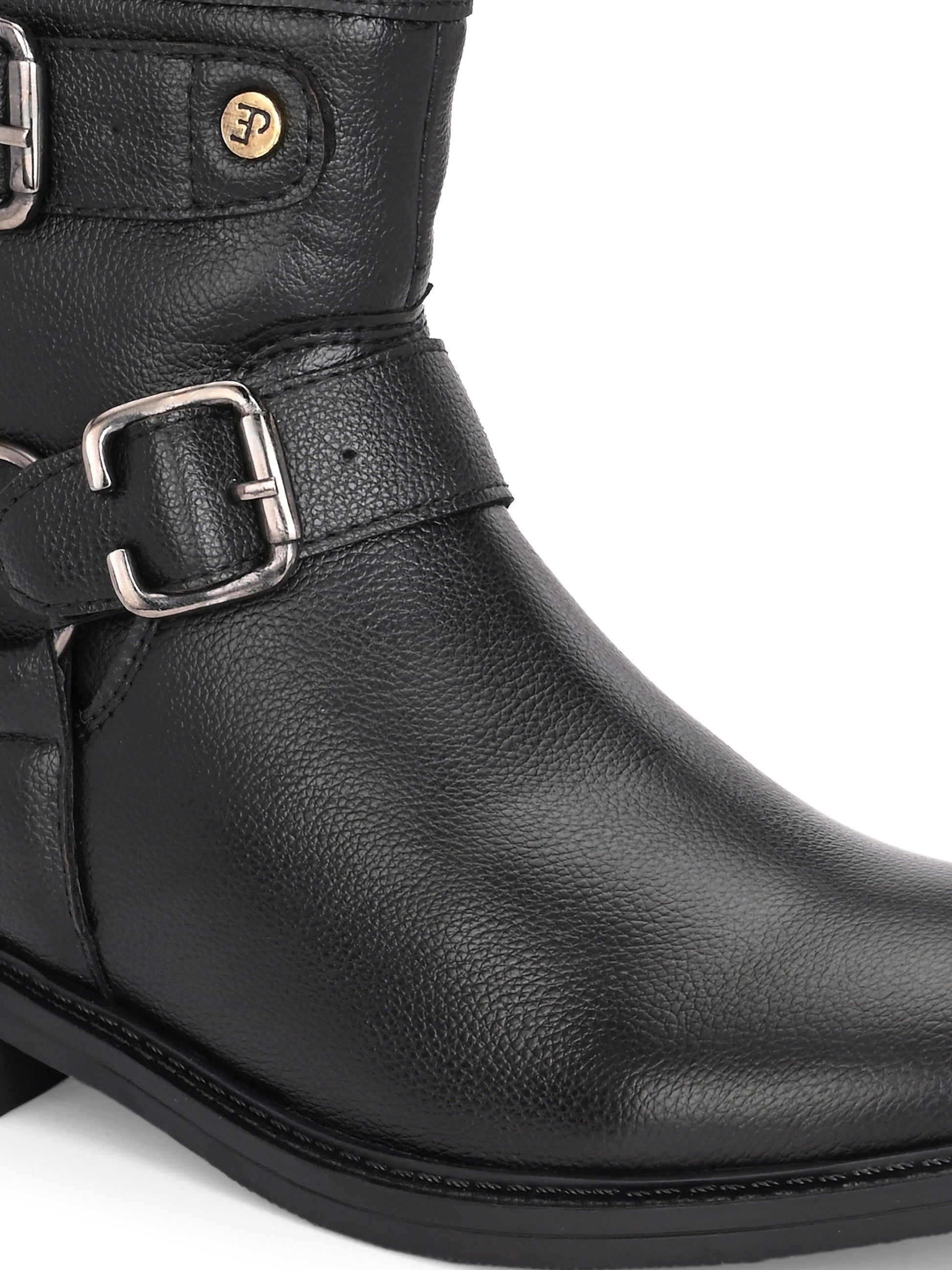 Black boots with silver buckle accents and a low heel, perfect for casual or semi-formal wear.