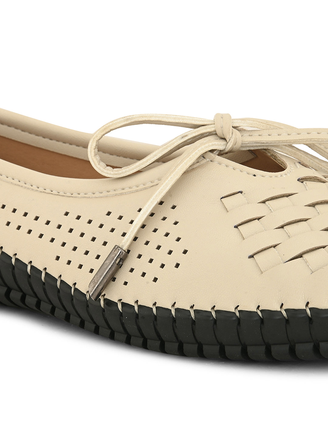 A beige women's flat with a perforated woven upper, round toe, metallic-tipped bow, and flexible black rubber outsole for comfort and casual wear.