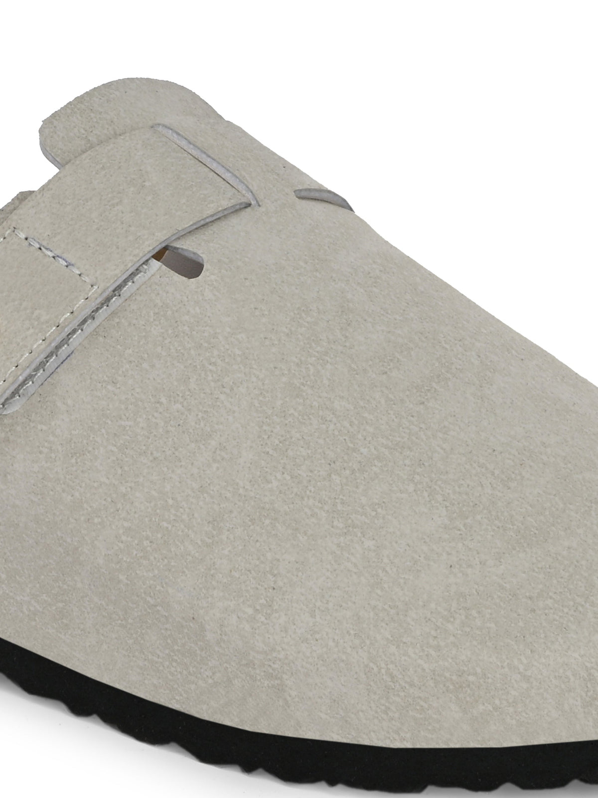Nude suede slip-on clog with a black rubber sole and adjustable strap.