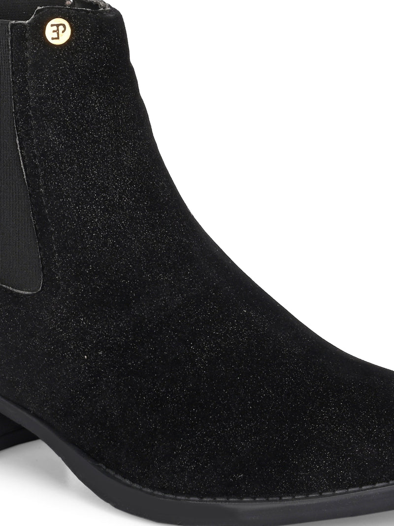 Charcoal suede slip-on boots with elastic side panels and a low block heel, featuring subtle gold detailing for a sleek, versatile look