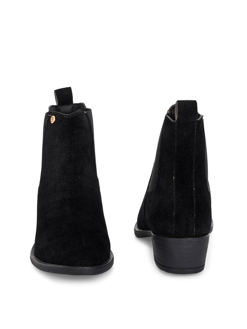 Charcoal suede slip-on boots with elastic side panels and a low block heel, featuring subtle gold detailing for a sleek, versatile look
