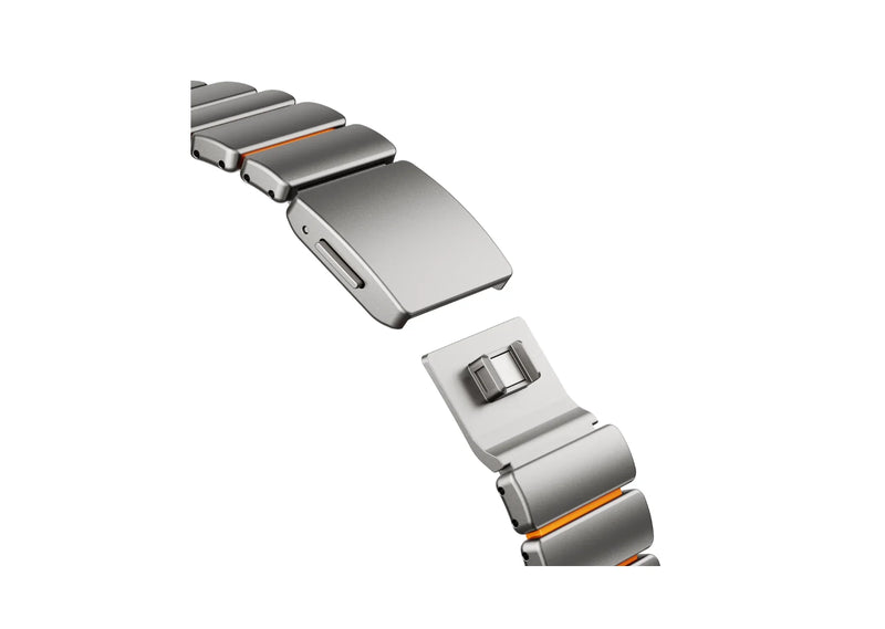 Close-up of the Silver Titanium exterior and premium orange silicone interior of the Titanium Fusion Apple Watch Strap