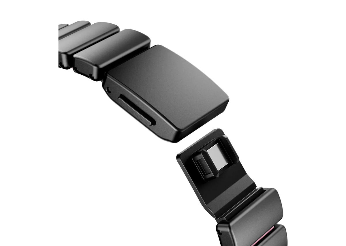 Luxury black stainless steel Apple Watch band with pink silicone inner lining shown partially open, highlighting flexible construction and secure butterfly clasp for Apple Watch Ultra 3, Series 11 and Apple Watch SE.