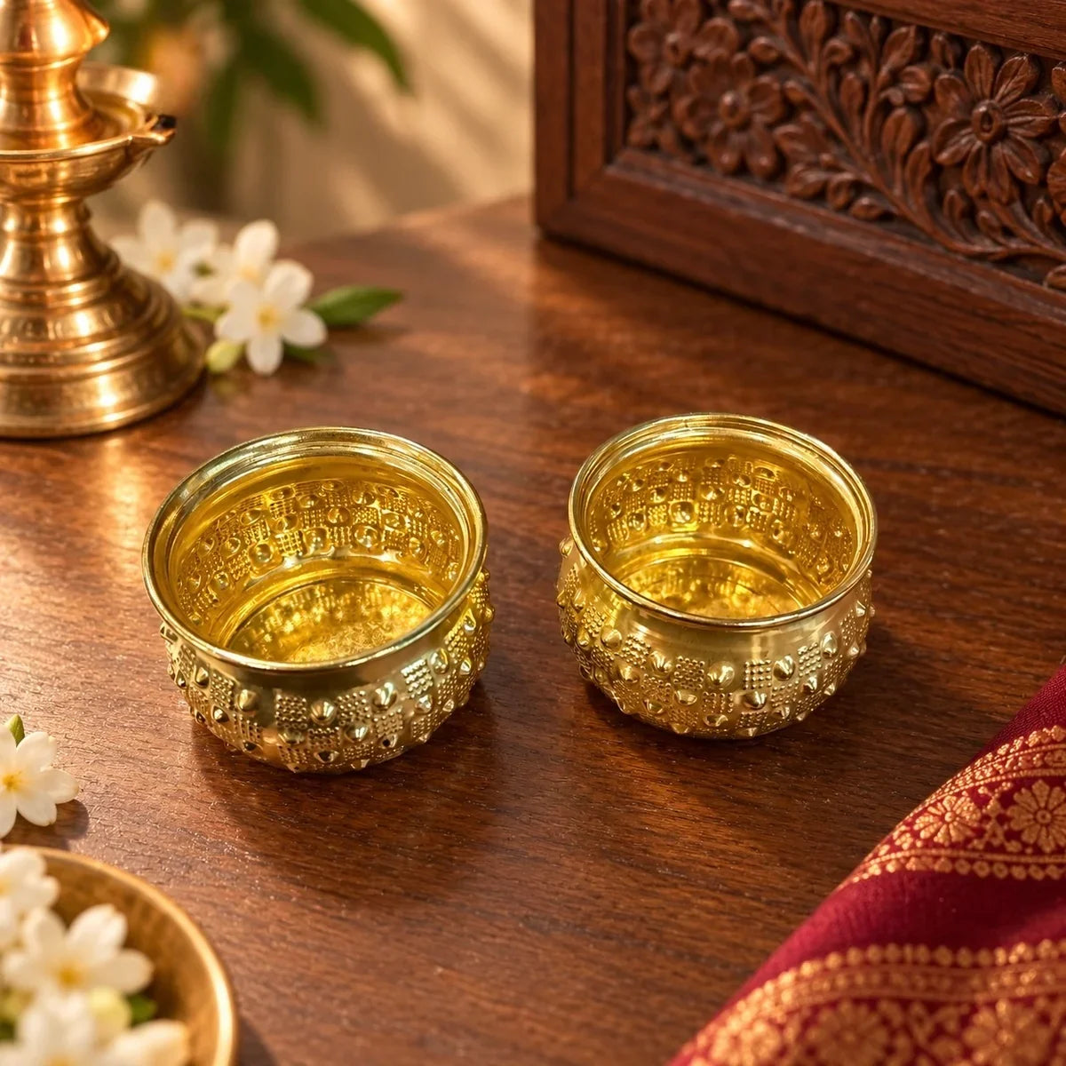 Brass Decorative Bowl Set of 2, two hobnail-textured pooja bowls beside a brass diya. Zishta Navratri Return Gifts.