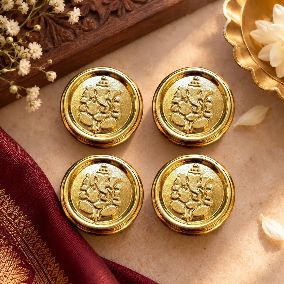 Brass Ganesha Dibbi Set of 4, round boxes with embossed Ganesh lid and ridged rim. Zishta Navratri Return Gifts.