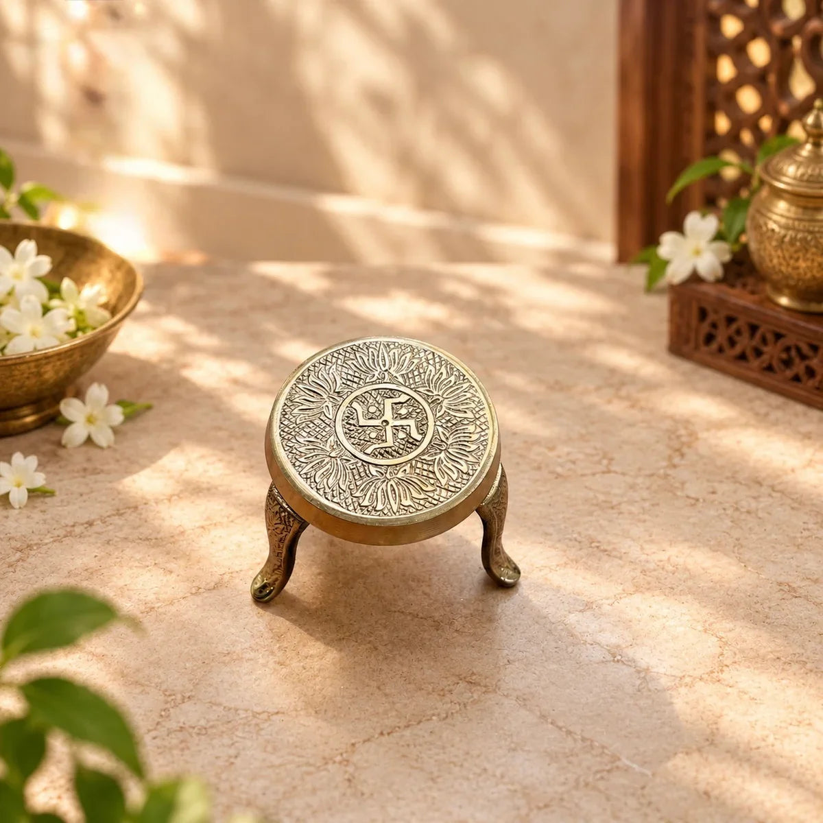 Brass Mukkali Round Small with swastik and lotus engraving, a three-legged pooja stand. Zishta Return Gifts.