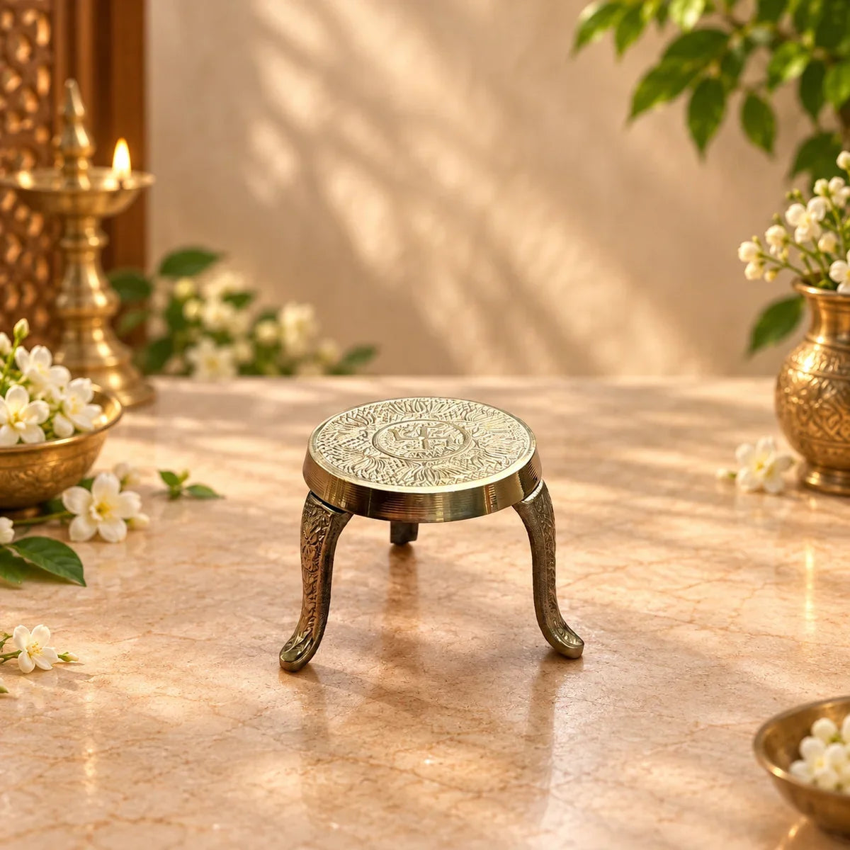 Brass Mukkali Round Small showing its carved tripod legs, used to raise a kalash or idol during pooja. Zishta Return Gifts.