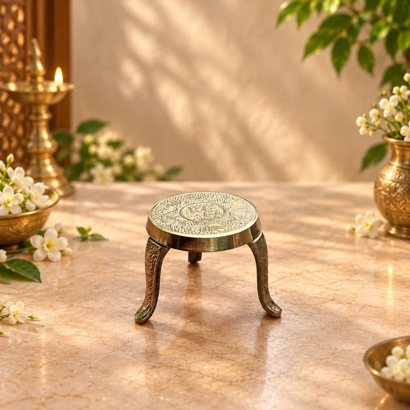 Brass Mukkali Round Small showing its carved tripod legs, used to raise a kalash or idol during pooja. Zishta Return Gifts.