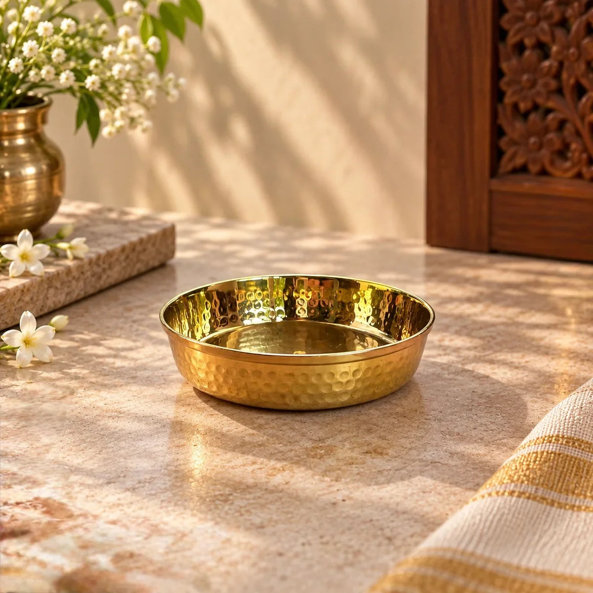 Close-up of the hammered brass finish on the Brass Pooja Plate Small, styled with jasmine flowers for pooja decor. Zishta Return Gifts.