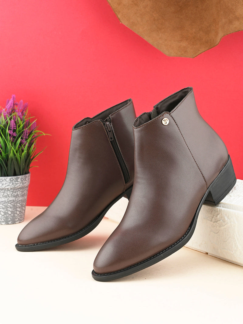 Brown leather ankle boots with a pointed toe, side zipper, and low block heel.