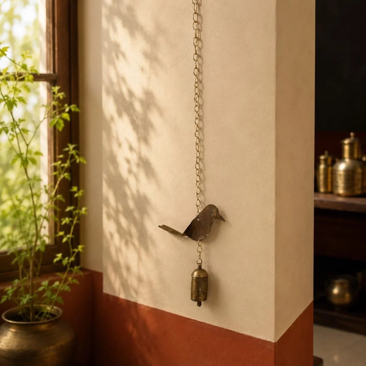 Copper coated iron bird wall hanging bell with chain, handcrafted Kutch metal wall art.  Zishta Traditional Home Decor.