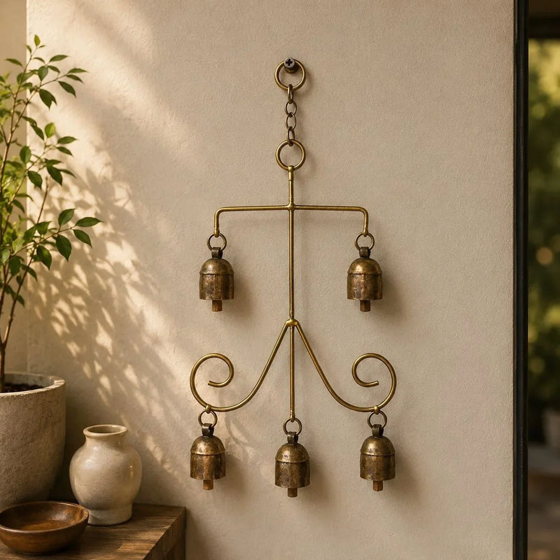 Copper coated iron wall hanging with five decorative bells - Vriksha design on a wall. Zishta Home Decor.