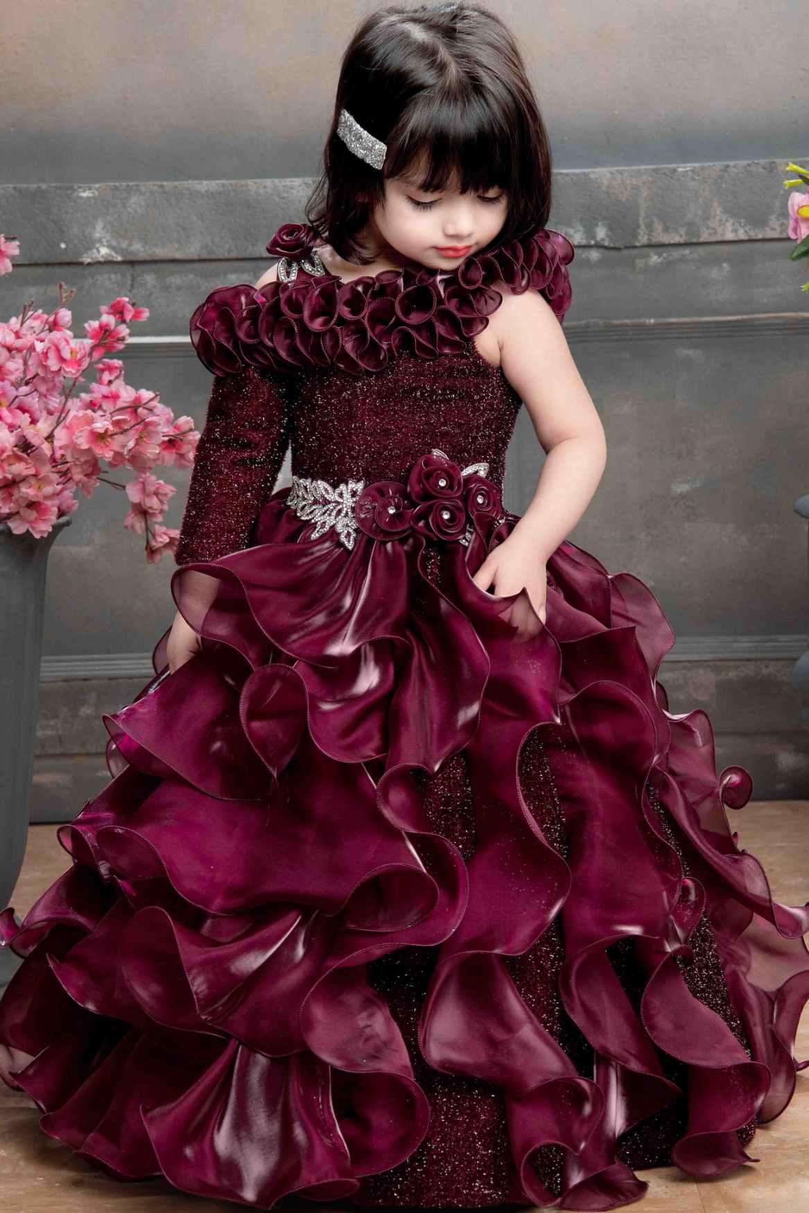 Designer Multilayer Ruffled Maroon Gown With Floral Embellishments For Girls