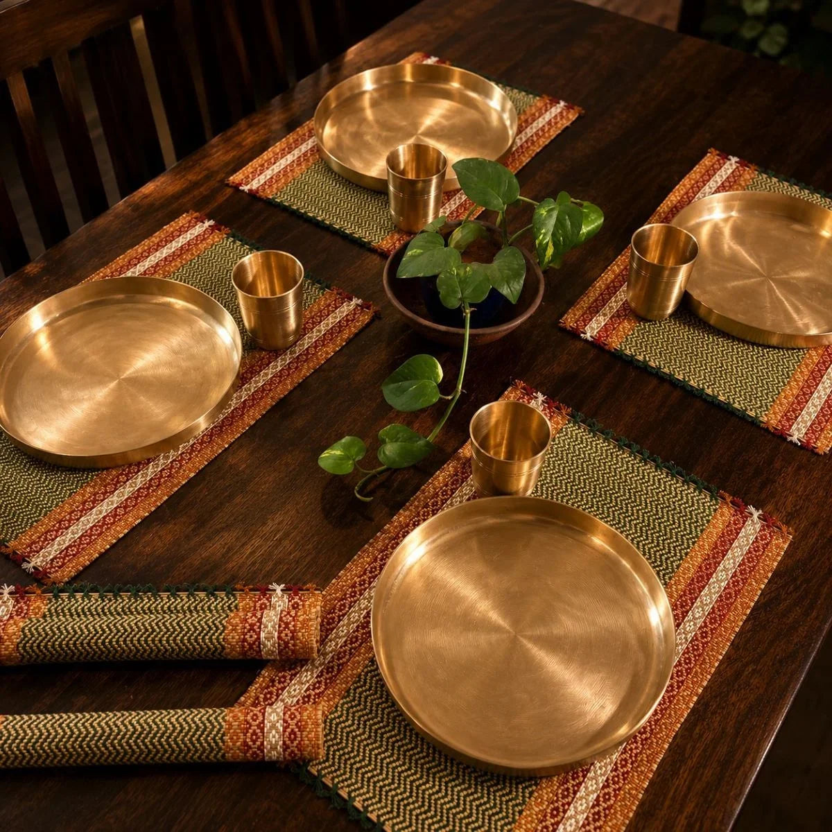 Madur table mat set emerald styled with kansa plates for dining. Zishta Home Decor.