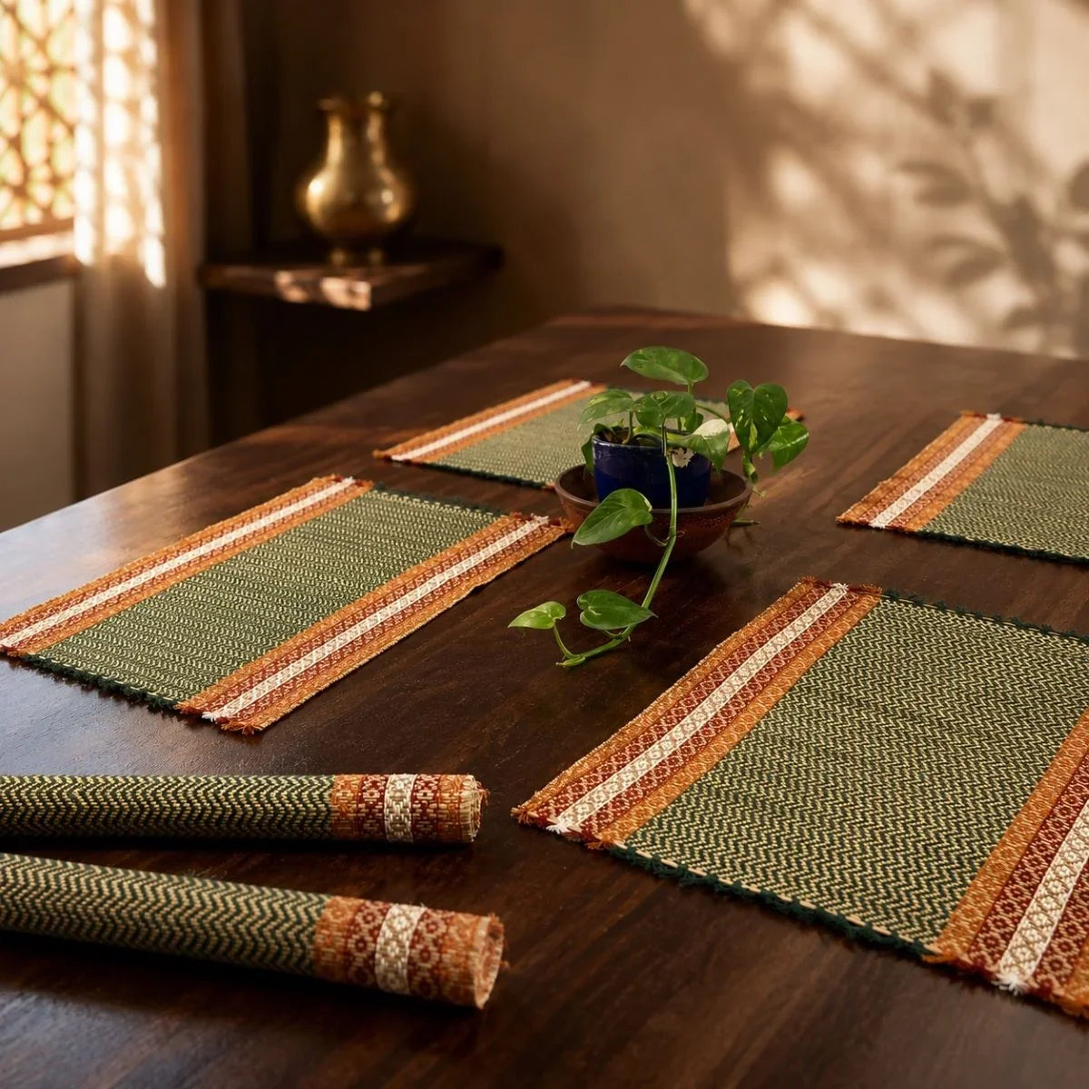 Madur table mat set emerald placemats with a potted plant on a table. Zishta Home Decor.