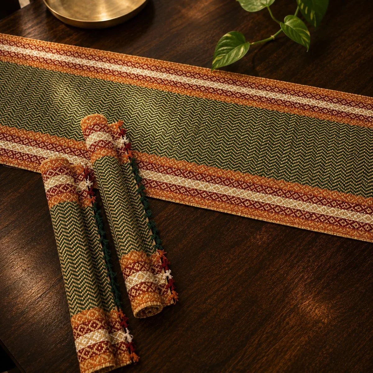 Madur table mat set in emerald with runner on a wooden dining table. Zishta Home Decor.