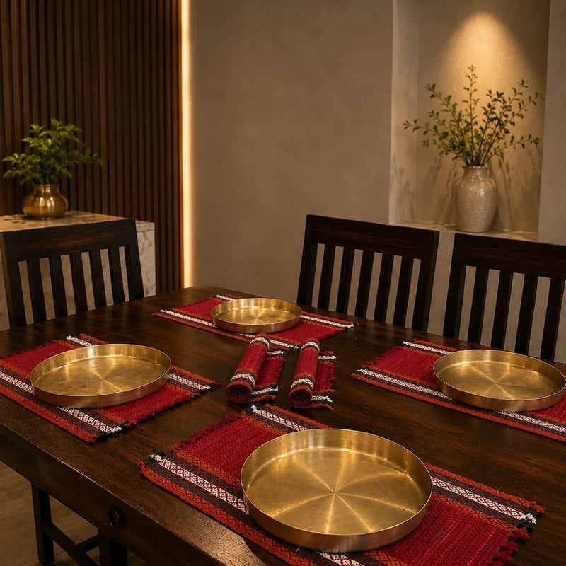Madur table mat set sindoor styled with kansa plates for dining. Zishta Home Decor.