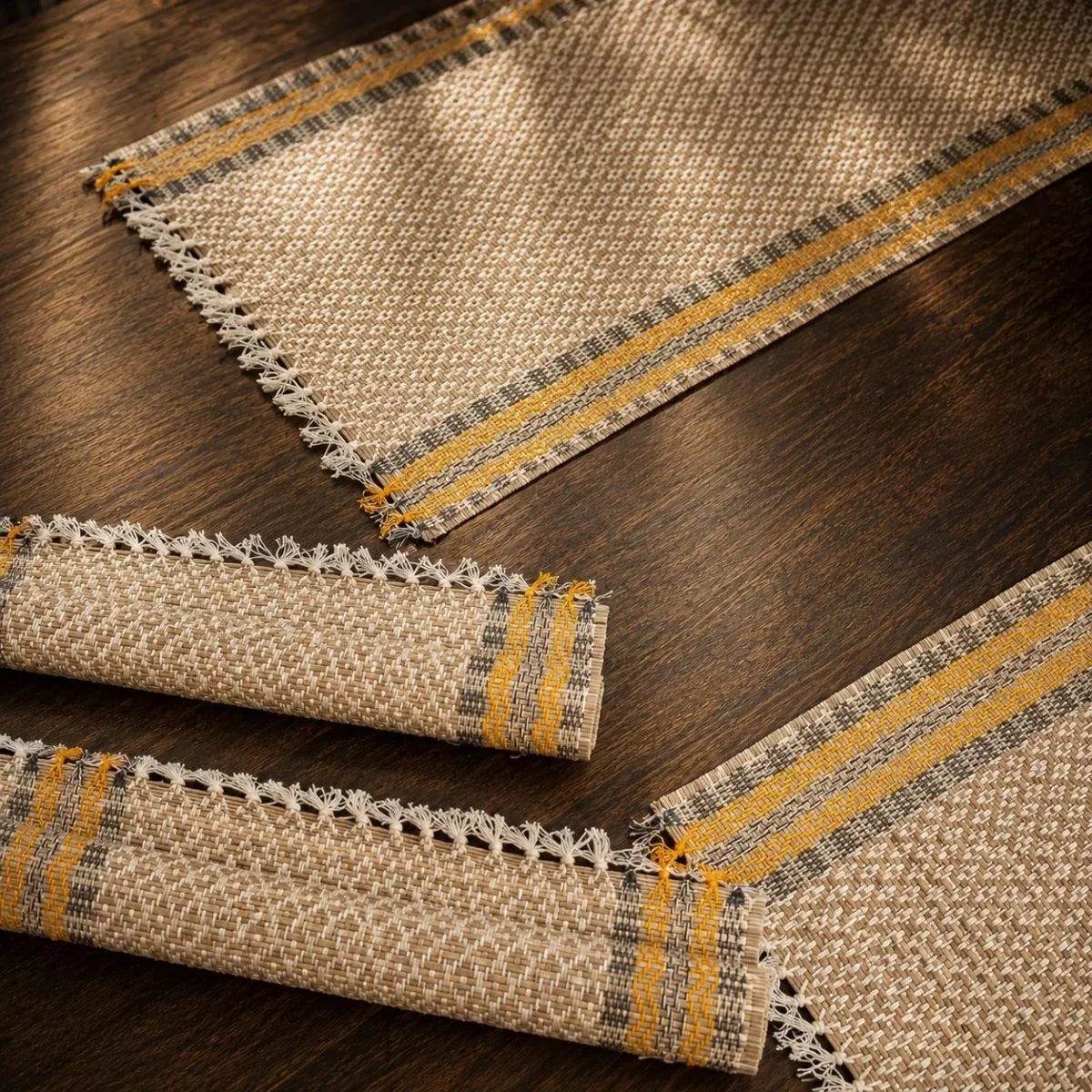 Close-up of madur table mat set badami weave with mustard stripe border. Zishta Dining Table Decor.