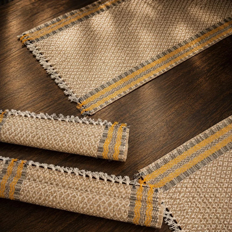 Close-up of madur table mat set badami weave with mustard stripe border. Zishta Dining Table Decor.
