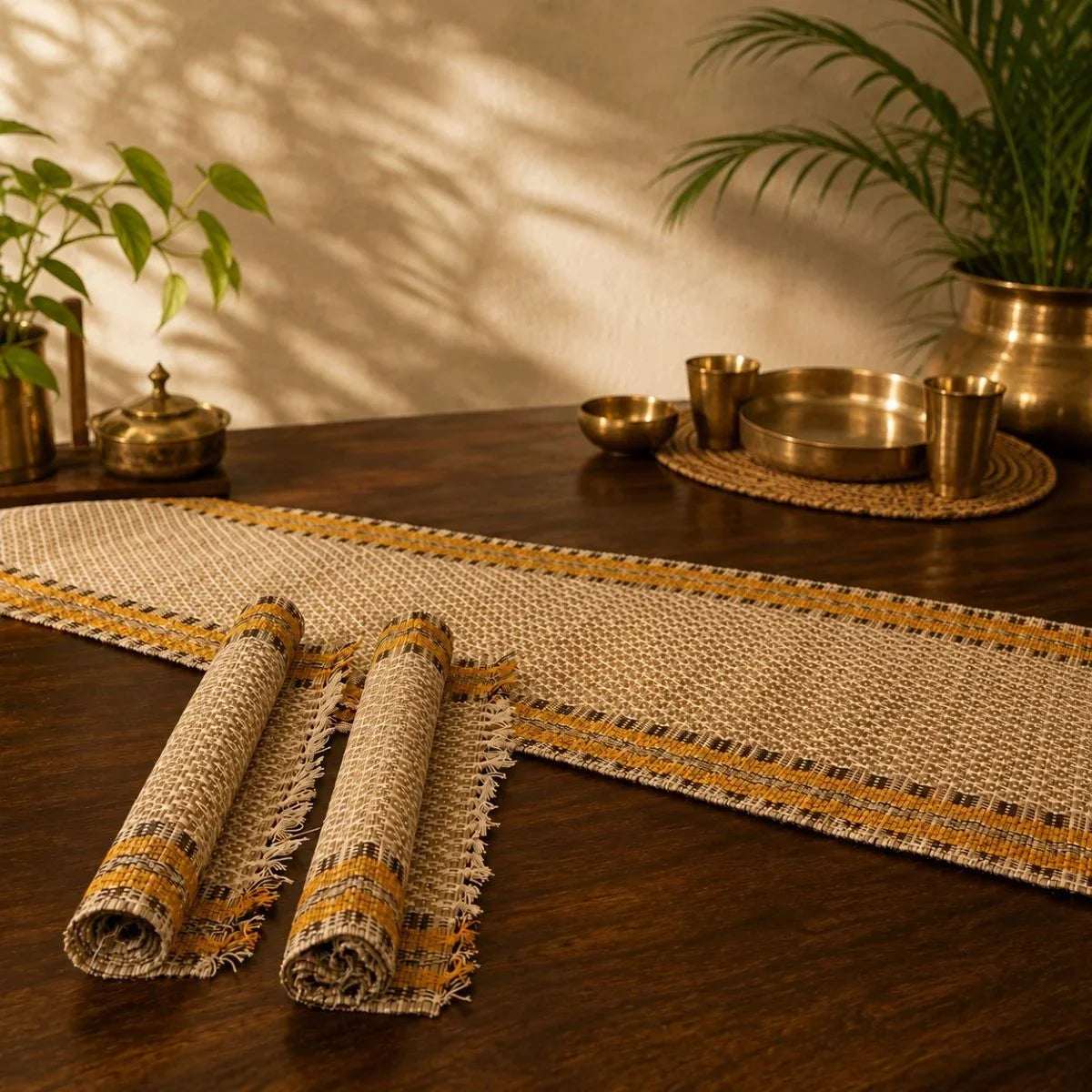 Madur table mat set in badami with runner on a wooden dining table. Zishta Dining Table Decor.