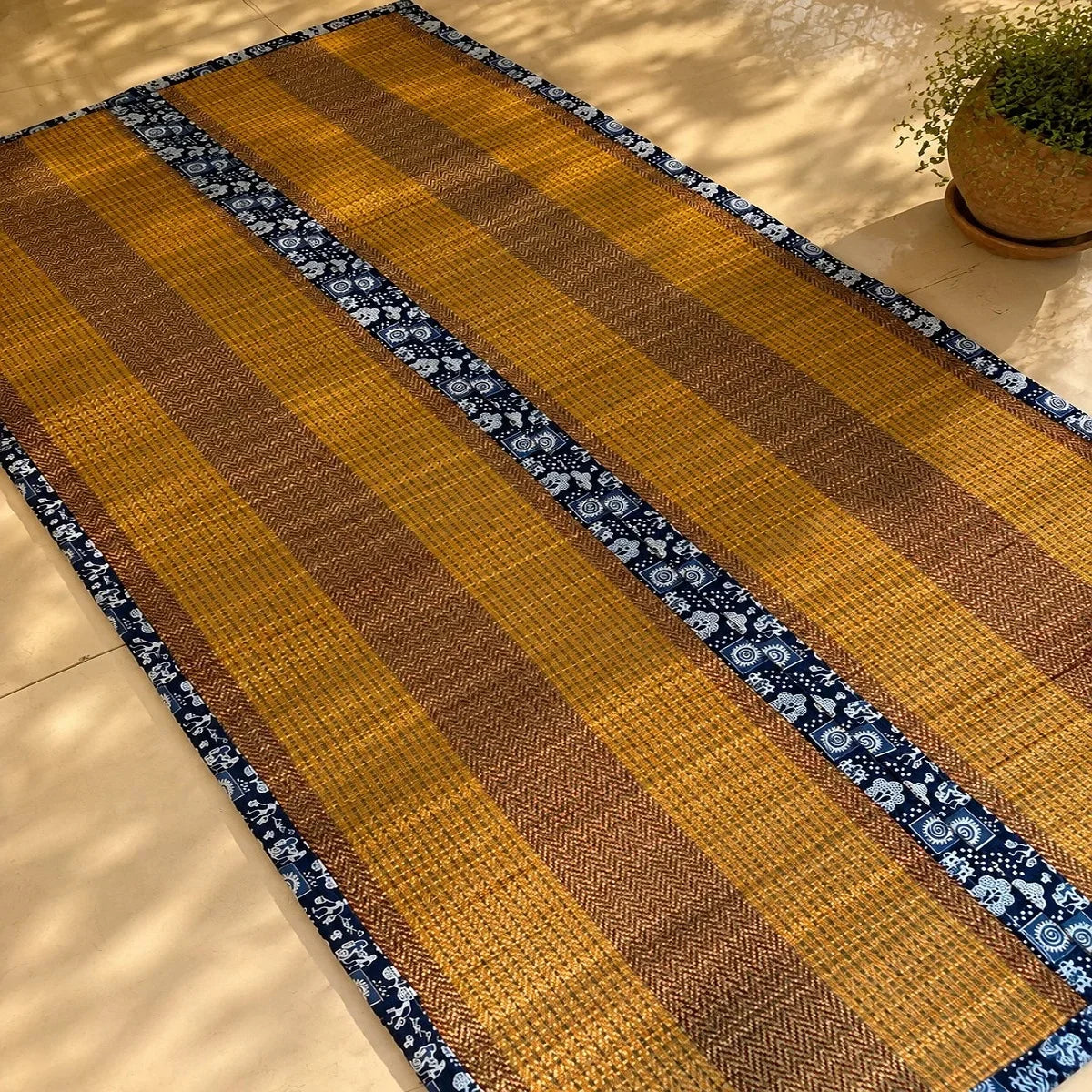 Madurkathi mat two fold with cushion in mustard weave and indigo border. Zishta Home Decor.