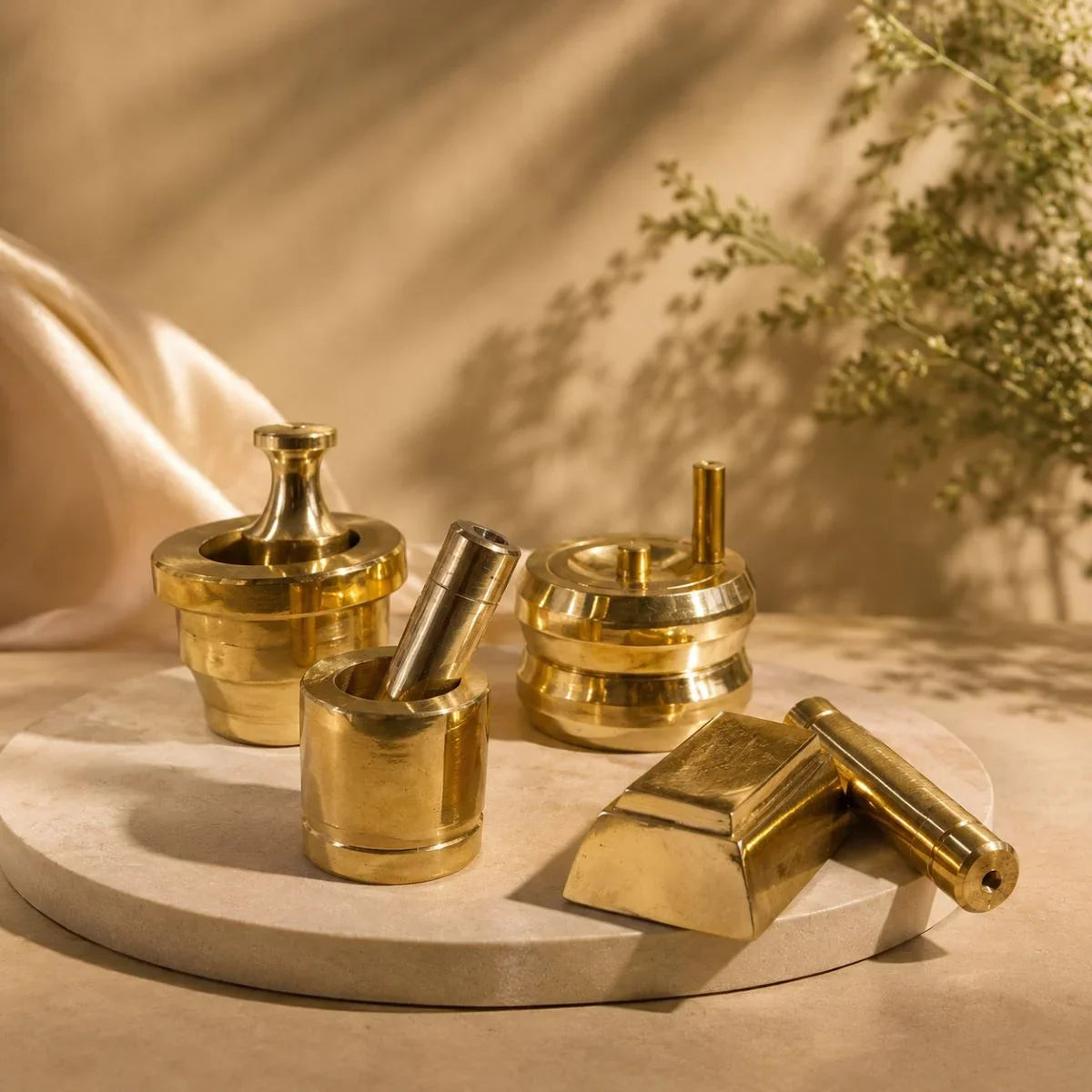 Miniature brass grinding tools-Gowramma set displayed on marble tray. Zishta Housewarming Gifts.