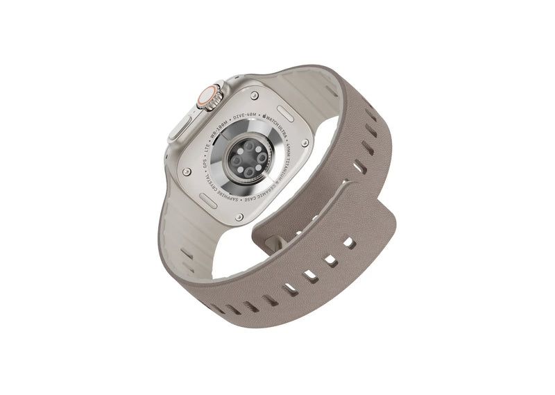 Misty Grey & Starlight Apple Watch strap with leather-textured silicone finish shown from an angled rear view