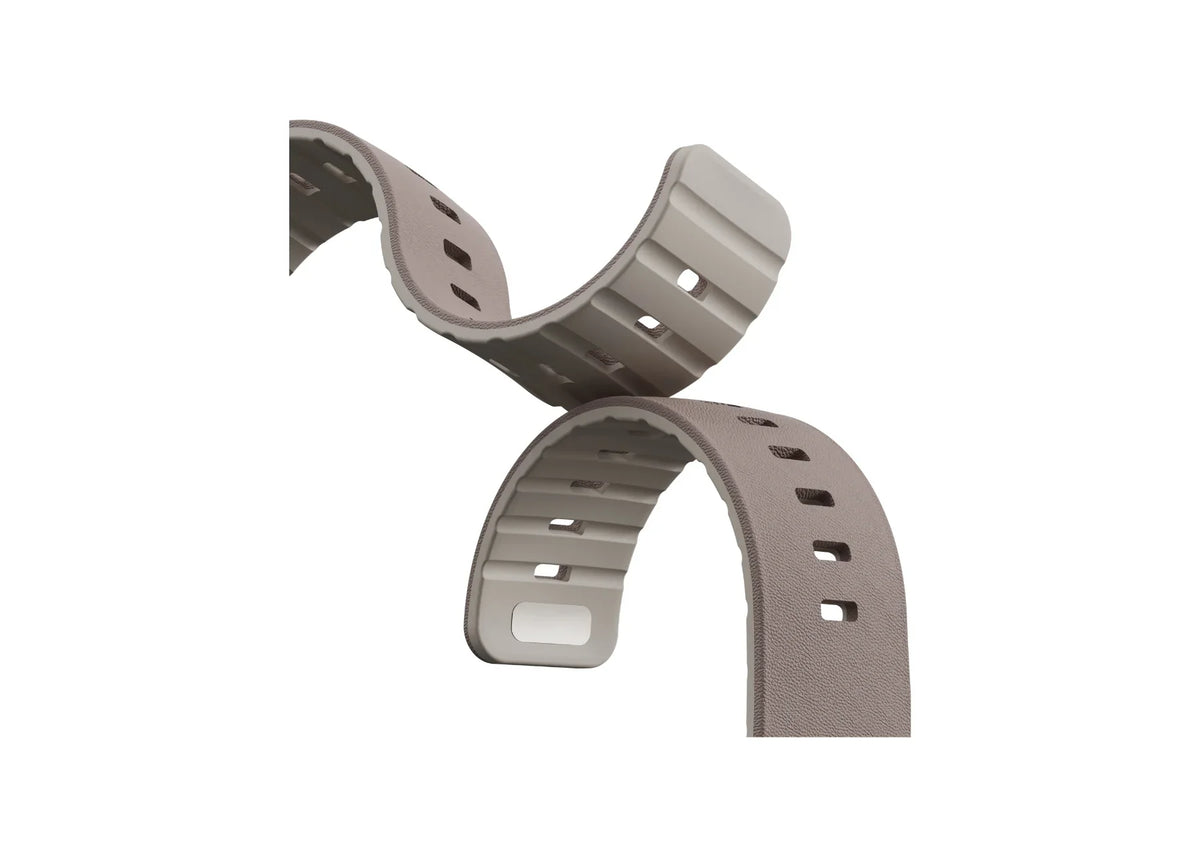 Close-up of Misty Grey & Starlight Apple Watch strap showing textured silicone surface, adjustment holes and magnetic closure