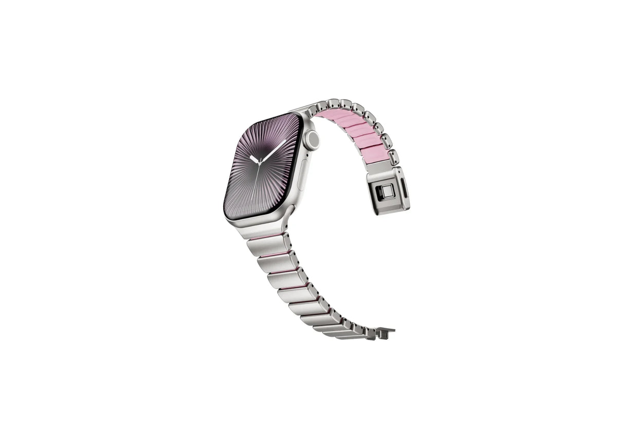 Luxury silver stainless steel Apple Watch band with pink silicone inner lining shown partially open, highlighting flexible construction and secure butterfly clasp for Apple Watch Ultra 3, Series 11 and Apple Watch SE.