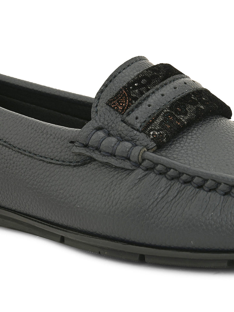 A single dark gray leather loafer with a textured sole and decorative strap across the front.