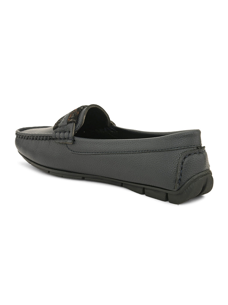 A single dark gray leather loafer with a textured sole and decorative strap across the front.