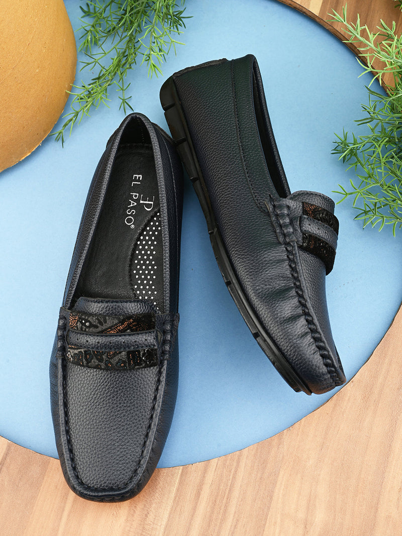 A single dark gray leather sleek loafer for women with a textured sole and decorative strap across the front.