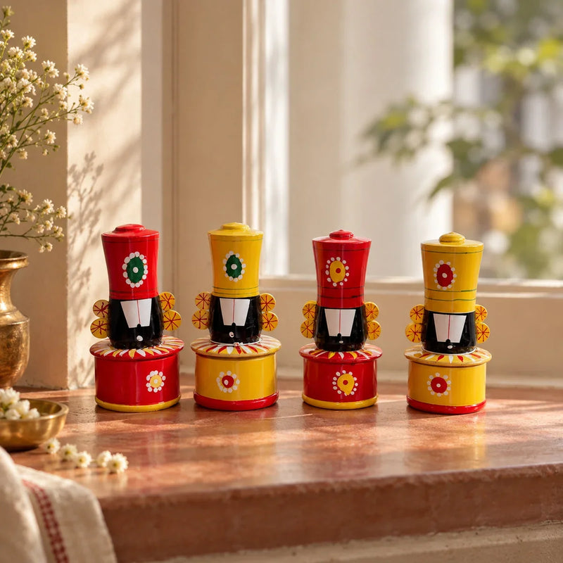 Wooden Balaji haldi kumkum box pair set of 2 in red and yellow, styled with a brass flower vase on a sunlit windowsill for Navratri. Zishta Navratri Return Gifts.