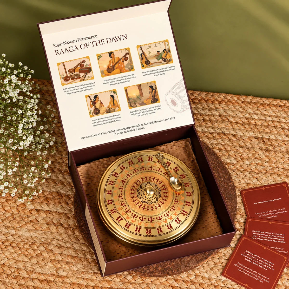 Worli art brass sweet box with a decorated brass spoon inside the open Suprabhatam Raaga of the Dawn box, with Sanskrit shloka cards. Zishta Diwali Corporate Gifts.